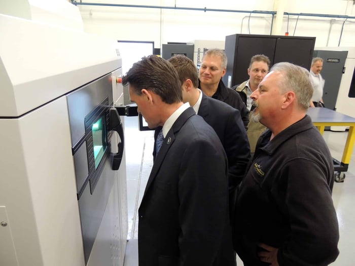 Mark Hackel observing FDM 3D printing during a tour of Baker Industries in Macomb, Michigan